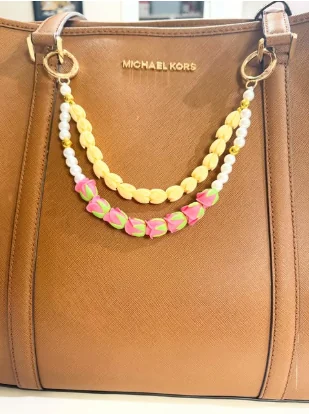 Purse decorated with floral charms
